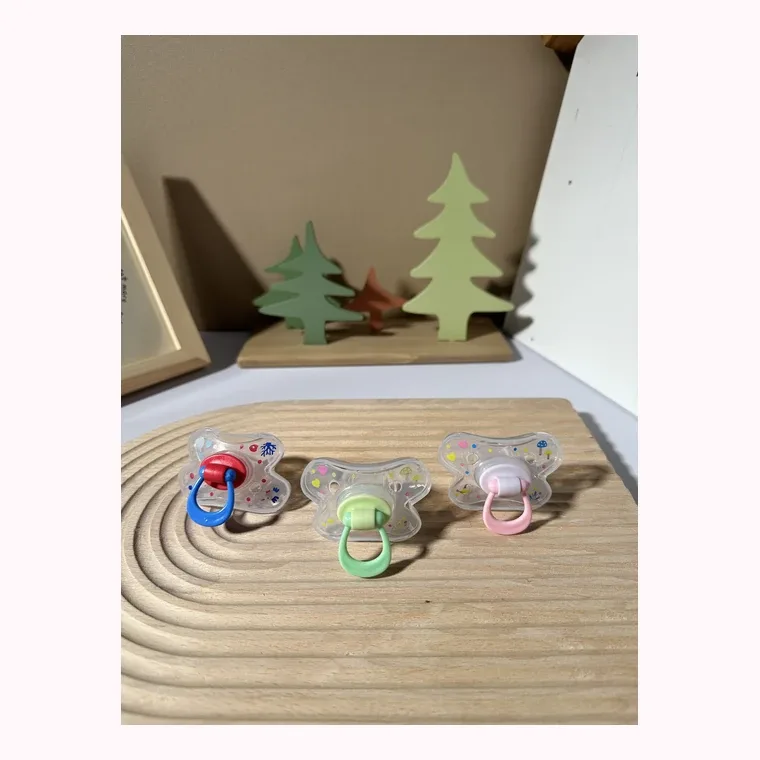 Pacifier, listed in pink, blue, green, purple